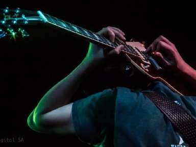 Joe playing guitar behind head 1